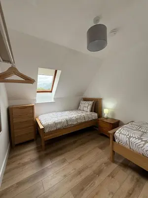 a bedroom with two beds and a window at Highland Nook for 4 in Fort William