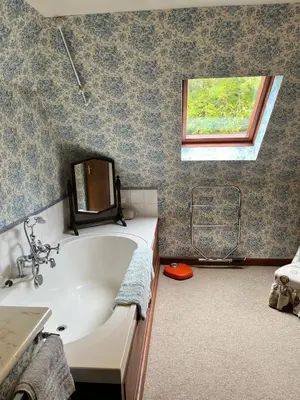 a bathroom with a bath tub and a window at Glenogle Highland Estate Home in Lochearnhead