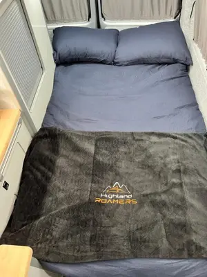 a bed in the back of a camper van at Campervan Scotland, Glen Roamer in Braco