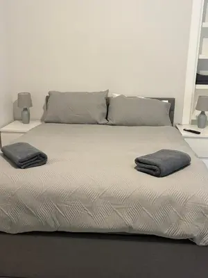 a large bed with two pillows on top of it at Seaside Escape 101 Nelson Largs in Largs