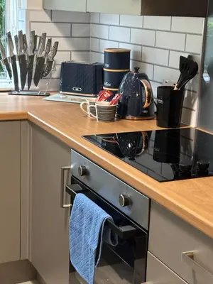 a kitchen with a stove with a blue towel on the oven at Seaside Escape 101 Nelson Largs in Largs