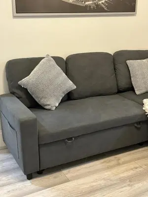 a gray couch with two pillows on top of it at Seaside Escape 101 Nelson Largs in Largs