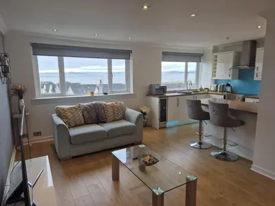 a living room with a couch and a table at Seafield Crt, North Shore Beach in Horse Isle