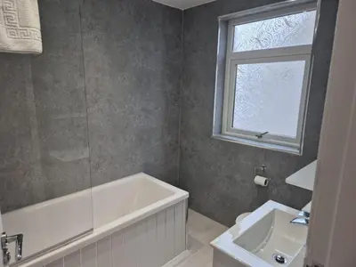 a bathroom with a tub and a sink and a window at Seafield Crt, North Shore Beach in Horse Isle