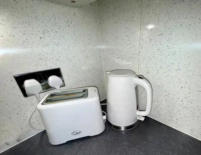 a white toaster sitting on top of a counter at Likewise Modern Two bedrooms Home for 4 in Glasgow Area in Pollokshaws