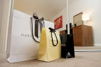 two shopping bags sitting on the floor in a room at Braid Apartments by Mansley in Edinburgh