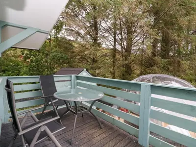 a table and chairs on the deck of a house at Scarba in Oban
