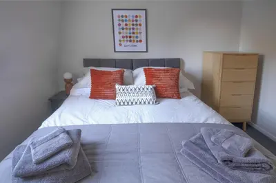 a bedroom with a bed with towels on it at Park View apartment, Gleneagles Village, Auchterarder in Auchterarder