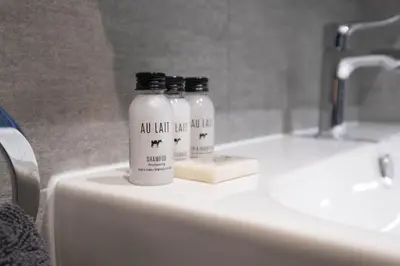 two bottles sitting on top of a bathroom sink at Park View apartment, Gleneagles Village, Auchterarder in Auchterarder