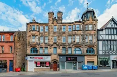 a large brick building on the corner of a street at Modern 3-Bed Flat Prime Falkirk Location in Falkirk