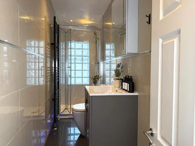 a bathroom with a sink and a toilet at Modern 3-Bed Flat Prime Falkirk Location in Falkirk