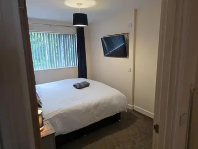 a bedroom with a white bed and a window at Balnakeil house