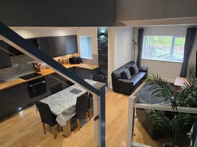 a living room with a kitchen and a dining room at Balnakeil house