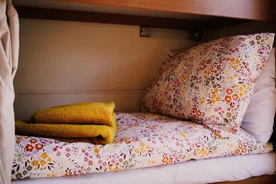 a bed with two pillows on top of it at Daley Croft Boutique Glamping in Taynuilt