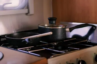 a pan sitting on top of a stove at Daley Croft Boutique Glamping in Taynuilt