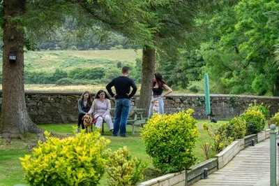 a group of people walking around in a park at Ashdale Cottage with Sauna, Plunge Pool, Games Room, Kit Drying Room in Isle of Arran