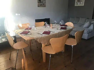 a dining room table with chairs and wine glasses at 2 new bold lawns leamington spa in Moffat
