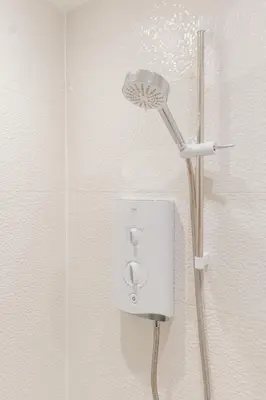 a shower with a shower head in a bathroom at Charming Central Mews Home with Secure Parking in Edinburgh
