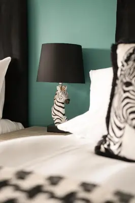 a zebra lamp sitting on top of a bed at Beechgrove House in Livingston