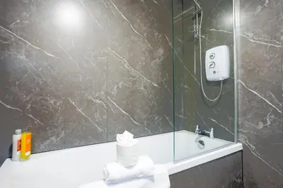 a bathroom with a sink and a mirror at Beechgrove House in Livingston