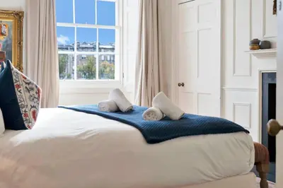 a bedroom with a bed with towels on it at GuestReady - Elegant Edinburgh Retreat in Edinburgh