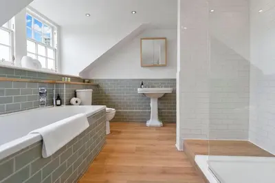 a bathroom with a bath tub and a sink at GuestReady - Elegant Edinburgh Retreat in Edinburgh