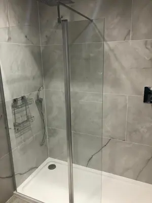 a shower with a glass door in a bathroom at Charming West End Flat in Edinburgh