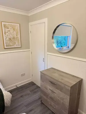 a room with a mirror and a wooden dresser at Modern 2BR Sleeps 4 Central Scotland with Parking in Banknock