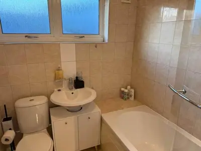 a bathroom with a toilet and a sink and a tub at Modern 2BR Sleeps 4 Central Scotland with Parking in Banknock