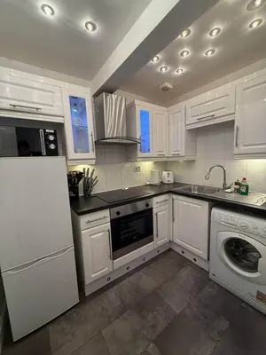 a kitchen with white cabinets and a sink and a dishwasher at 2BR Flat with Parking Near Glasgow Green and Parks in Glasgow