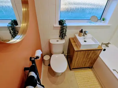 a bathroom with a toilet and a sink and a tub at Newly Refurbished 3 Bed House with 2-Sided Wood Burner and Garden in Edinburgh in Edinburgh