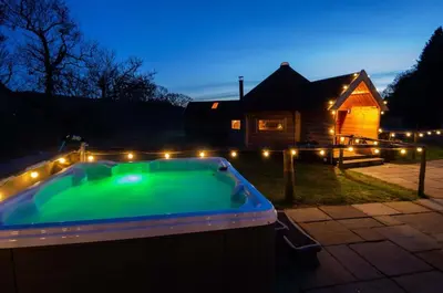 a swimming pool with lights in front of a house at Wildcat Lodge in Kilmichael Glassary