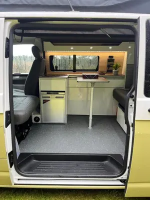 an open door of a van with a desk at Campervan Scotland, Ben Roamer in Dunblane
