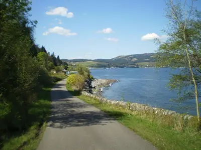 a road next to a body of water at Skye Lodge in Tighnabruaich