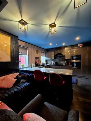 a living room with a couch and a kitchen at Ta'Pinu House and Spa in Horse Isle