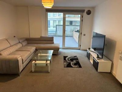 a living room with a couch and a tv at One Bedroom Apartment in Greenwich Peninsula in Moffat