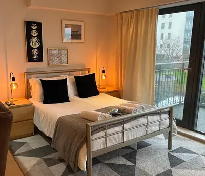 a bedroom with a bed and a large window at Pier House in Edinburgh