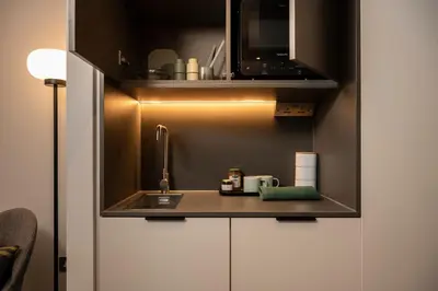 a kitchen with a sink and a microwave at The Wellington Glasgow by Adina in Glasgow