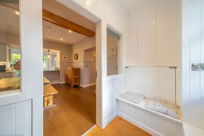 a hallway of a home with white walls at Stables Cottage in Dunira