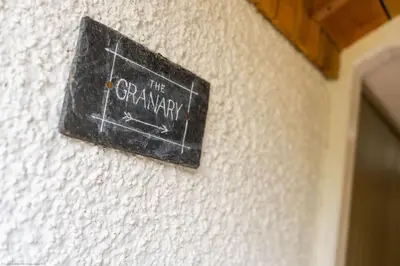 a sign on a wall that reads the garage at The Granary in Dunira