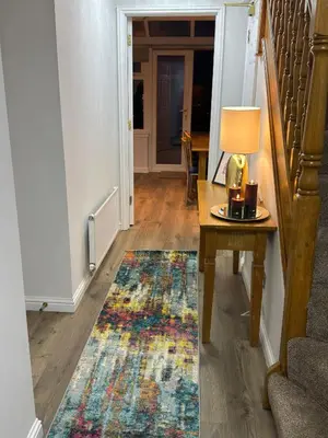 a hallway with a table with a lamp and a rug at Luxury townhouse in Stirling in Stirling