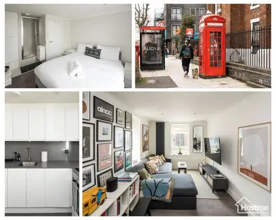 a hotel room with a bed and a phone booth at 1 Bed Flat in Shoreditch near Station by Hostroo in Moffat