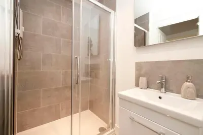 a bathroom with a shower and a sink at 1 bed in heart of Old Town with Castle Views in Edinburgh