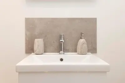 a white sink with two soap bottles on it at 1 bed in heart of Old Town with Castle Views in Edinburgh