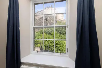 a window with a view of the eiffel tower at 1 bed in heart of Old Town with Castle Views in Edinburgh