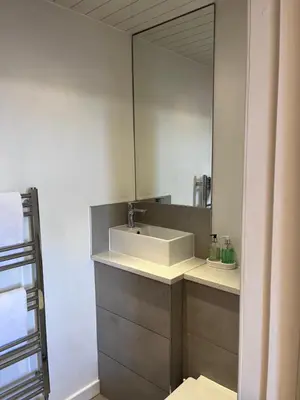 a bathroom with a sink and a mirror at Ravenswood Guest House in Stirling