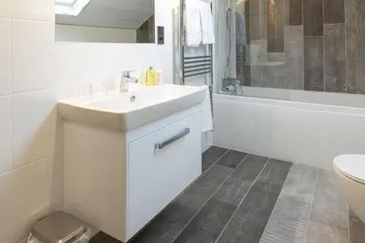 a white bathroom with a sink and a toilet at Sunset View in Innellan