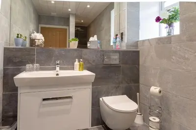 a bathroom with a white sink and a toilet at Sunset View in Innellan