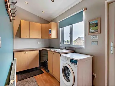 a laundry room with a washer and a window at Drovers Lodge, farm retreat in rural Lanarkshire, family and pet friendly, onsite craft distillery, perfect location for exploring central Scotland in Forth