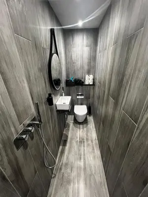 a bathroom with a toilet and a sink and a mirror at Angel Cottage, Strone in Dunoon